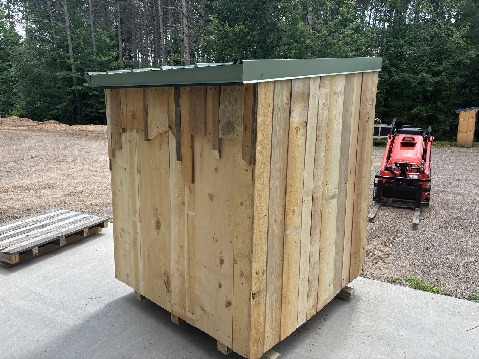 Back of a green-roofed shed on skids